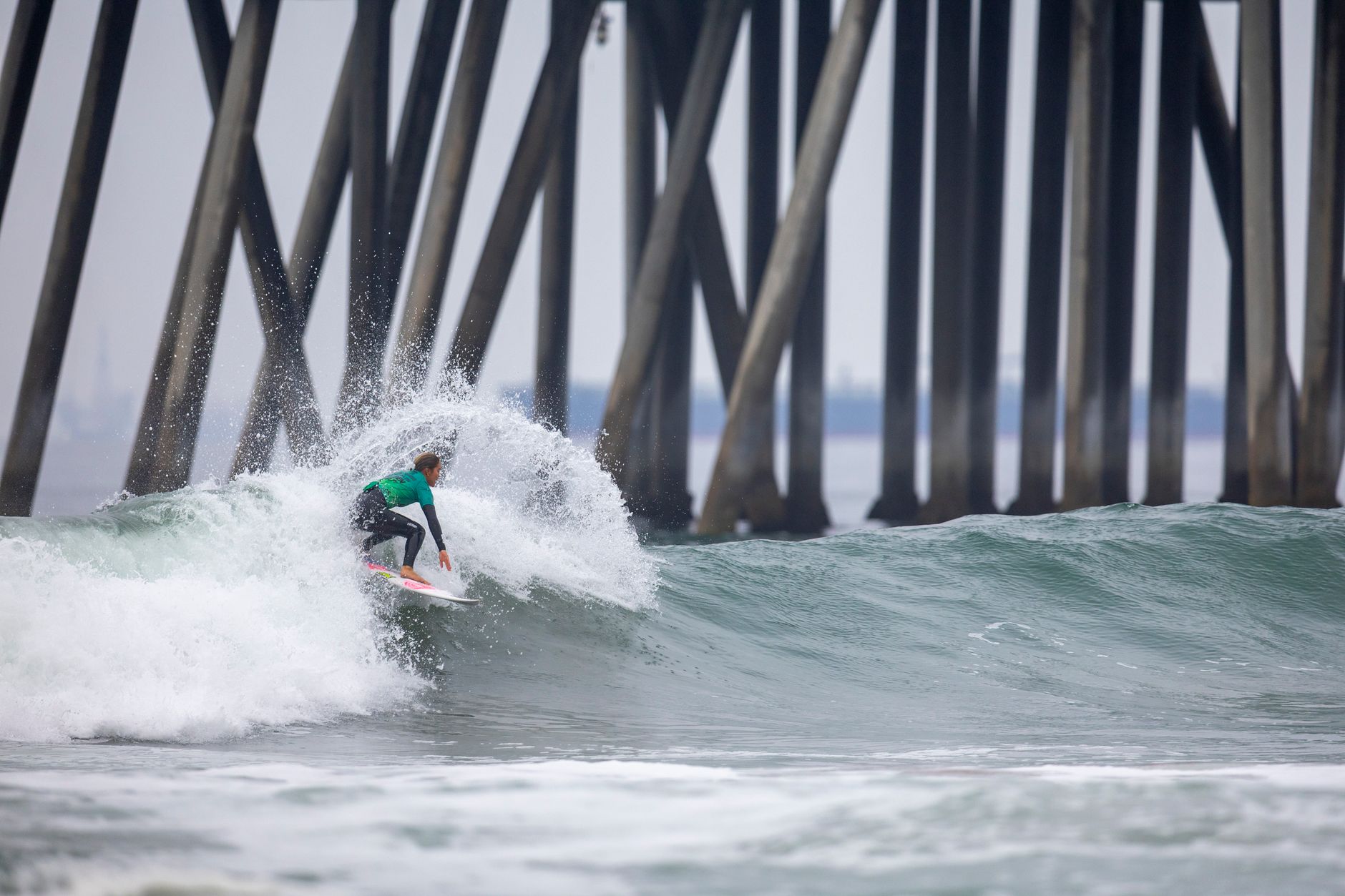 Local SEO in Huntington Beach, CA near Main Street Huntington Beach | OCWebPros. Dynamic shot of a surfer riding a wave near 