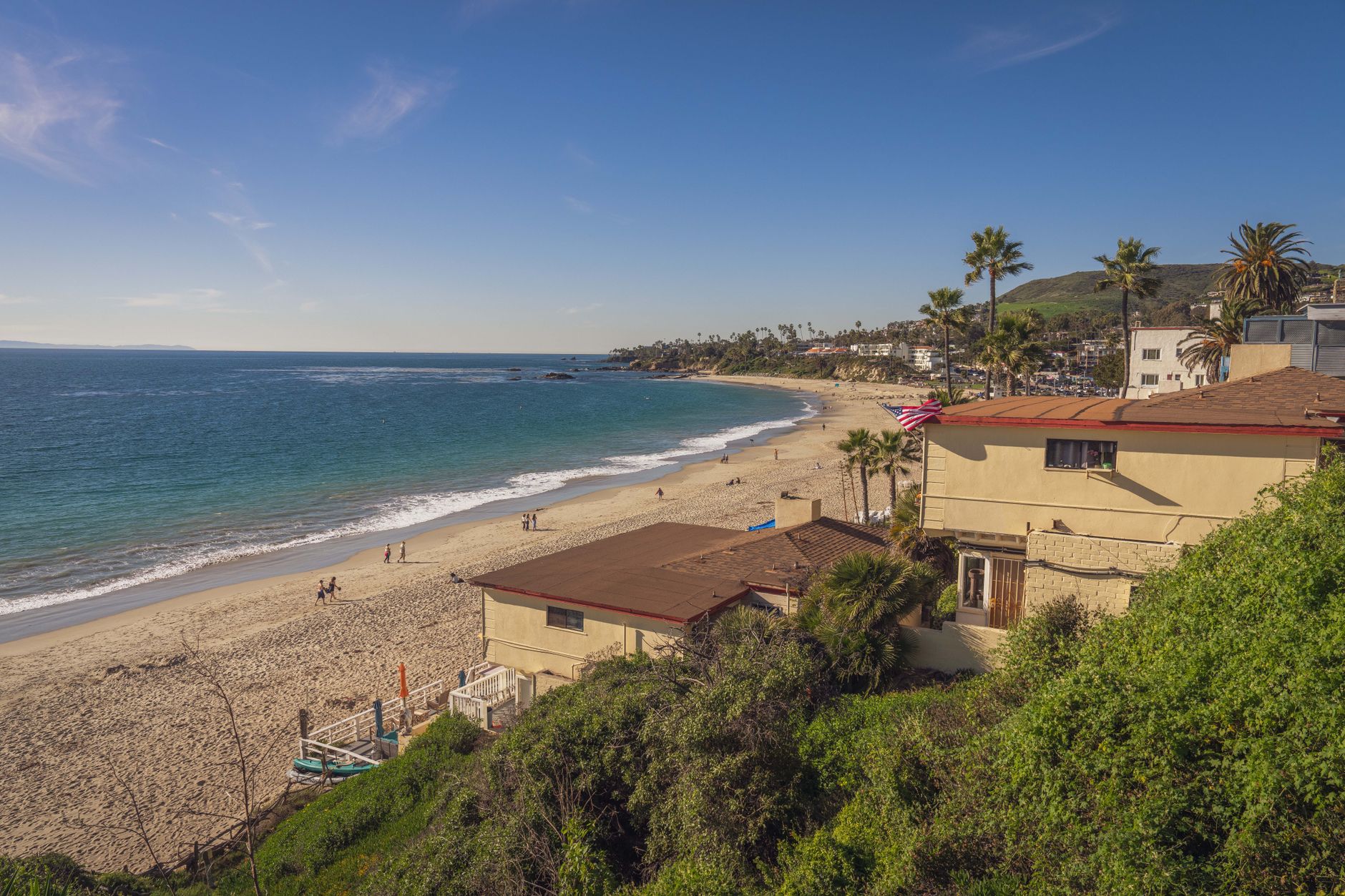 Local SEO in Laguna Beach, CA near Downtown Laguna & Forest Avenue | OCWebPros. A picturesque view of a sandy beach in Laguna