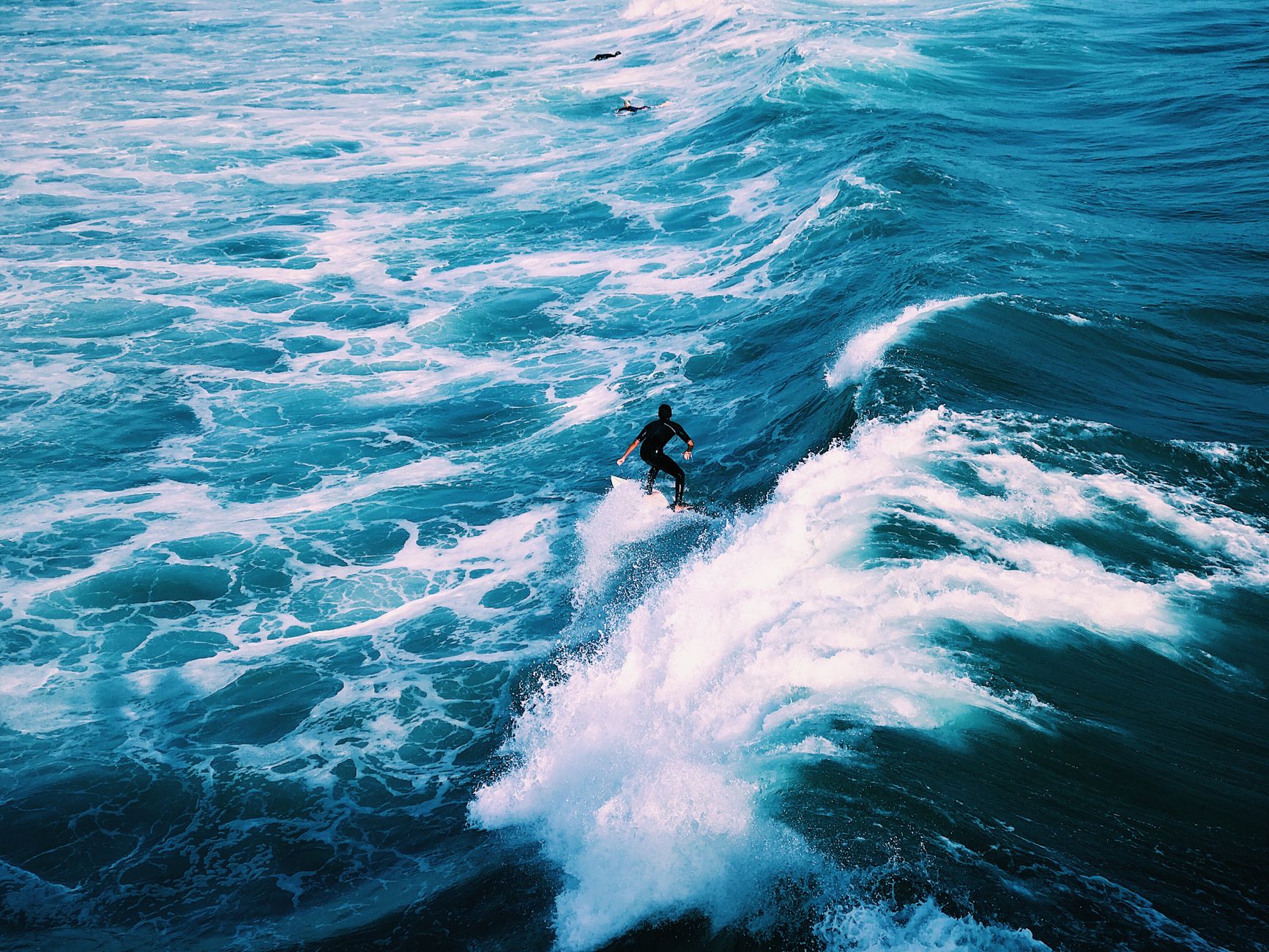 Local SEO in San Clemente, CA near Avenida Del Mar downtown | OCWebPros. Dynamic shot of a surfer catching waves in ocean wat