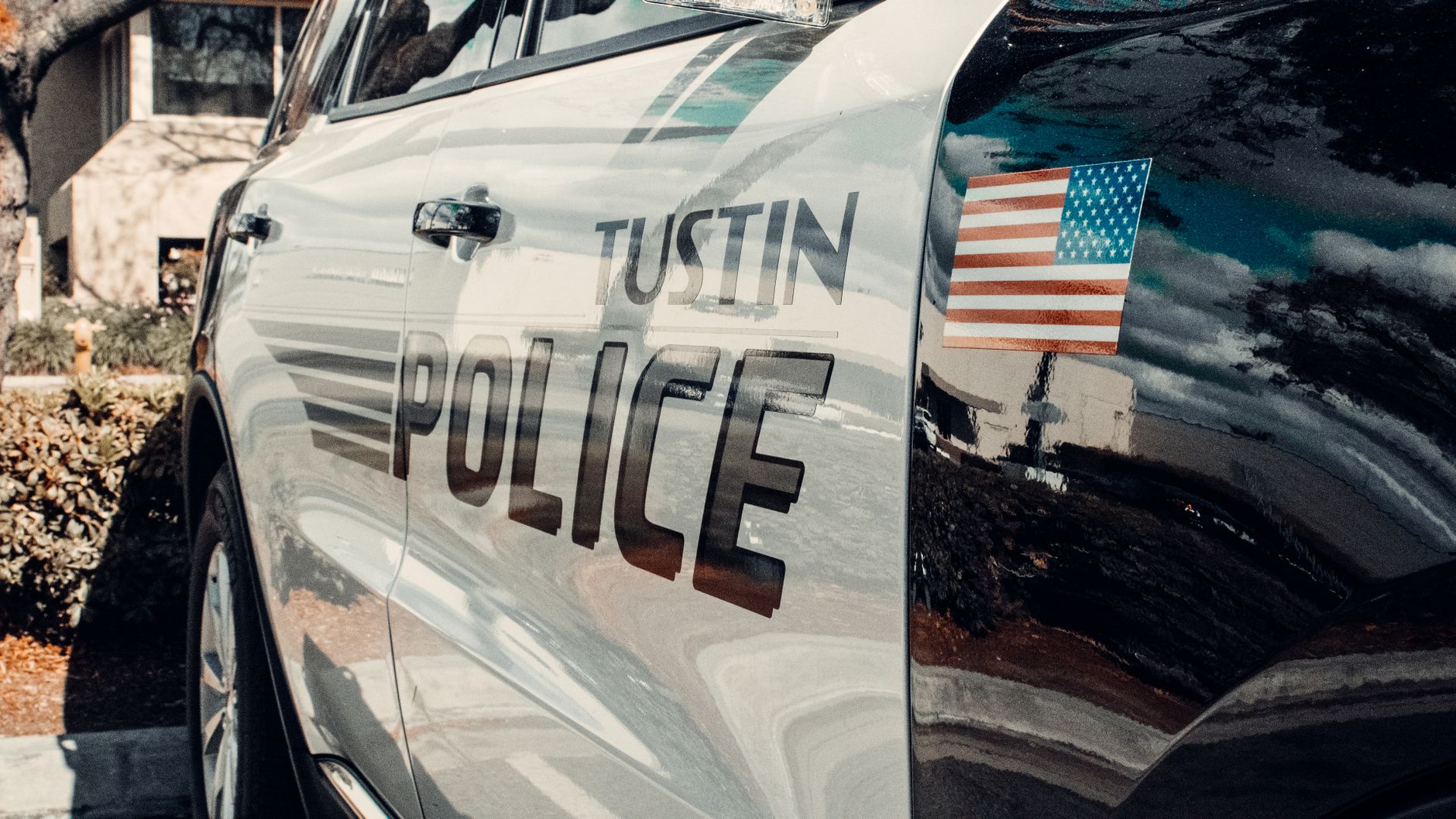 Local SEO in Tustin, CA near Old Town Tustin & Main Street | OCWebPros. Reflective image of a Tustin police car parked outdoo